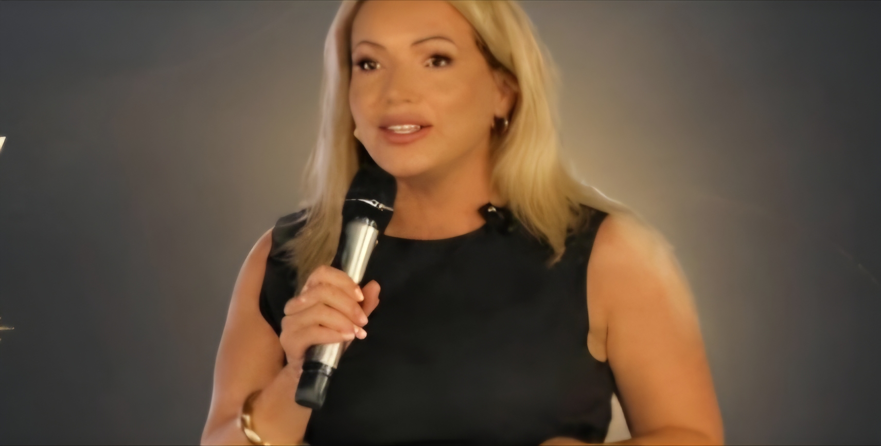 Joanne Kimberley speaking into a microphone